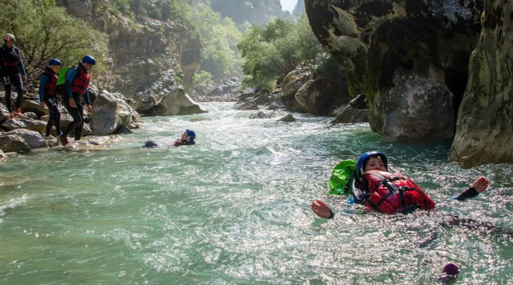 Aqua hiking between waves and rocks